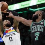 
              Minnesota Timberwolves' D'Angelo Russell (0) shoots against Boston Celtics' Jaylen Brown (7) during the first half of an NBA basketball game, Friday, Dec. 23, 2022, in Boston. (AP Photo/Michael Dwyer)
            