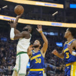 
              Boston Celtics guard Jaylen Brown, left, shoots next to Golden State Warriors guard Stephen Curry (30) during the first half of an NBA basketball game in San Francisco, Saturday, Dec. 10, 2022. (AP Photo/Godofredo A. Vásquez)
            