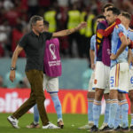 
              Spain's head coach Luis Enrique, center, talks to his players after the penalty shootout at the World Cup round of 16 soccer match between Morocco and Spain, at the Education City Stadium in Al Rayyan, Qatar, Tuesday, Dec. 6, 2022. (AP Photo/Luca Bruno)
            