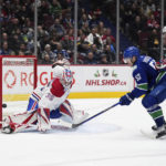 
              Vancouver Canucks' Bo Horvat (53) scores against Montreal Canadiens goalie Sam Montembeault (35) as Joel Edmundson (44) and Kaiden Guhle (21) watch during the third period of an NHL hockey game in Vancouver, British Columbia, Monday, Dec. 5, 2022. (Darryl Dyck/The Canadian Press via AP)
            