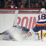 
              Colorado Avalanche goaltender Alexandar Georgiev, left, stops a shot off the stick of New York Islanders left wing Anthony Beauvillier during a shootout in of an NHL hockey game, Monday, Dec. 19, 2022, in Denver. (AP Photo/David Zalubowski)
            