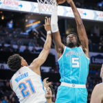 
              Charlotte Hornets center Mark Williams (5) shoots around Oklahoma City Thunder guard Aaron Wiggins (21) during the first half of an NBA basketball game Thursday, Dec. 29, 2022, in Charlotte, N.C. (AP Photo/Rusty Jones)
            