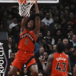 
              Toronto Raptors forward O.G. Anunoby hangs from the basket as he watches his shot bounce off the rim during the first half of an NBA basketball game against the Los Angeles Lakers on Wednesday, Dec. 7, 2022, in Toronto. (Chris Young/The Canadian Press via AP)
            