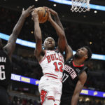 
              Chicago Bulls guard Ayo Dosunmu (12) is fouled by Houston Rockets forward Tari Eason (17)  while shooting during the second half of an NBA basketball game Monday, Dec. 26, 2022, in Chicago. (AP Photo/Quinn Harris)
            