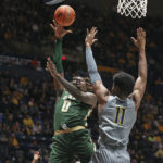 
              UAB forward Javian Davis (0) shoots while defended by West Virginia forward Mohamed Wague (11) during the first half of an NCAA college basketball game in Morgantown, W.Va., Saturday, Dec. 10, 2022. (AP Photo/Kathleen Batten)
            