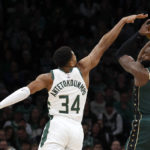 
              Boston Celtics guard Jaylen Brown (7) shoots as Milwaukee Bucks forward Giannis Antetokounmpo (34) reaches in to defend during the first half of an NBA basketball game, Sunday, Dec. 25, 2022, in Boston. (AP Photo/Mary Schwalm)
            