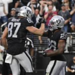 
              Las Vegas Raiders running back Josh Jacobs (28) celebrates his touchdown with tight end Foster Moreau (87) during the first half of an NFL football game against the Los Angeles Chargers, Sunday, Dec. 4, 2022, in Las Vegas. (AP Photo/David Becker)
            