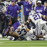 
              TCU wide receiver Quentin Johnston (1) and Kansas State safety Drake Cheatum (21) watch the ball following a fumble by TCU in the first half of the Big 12 Conference championship NCAA college football game, Saturday, Dec. 3, 2022, in Arlington, Texas. (AP Photo/LM Otero)
            