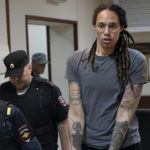 
              FILE - WNBA star and two-time Olympic gold medalist Brittney Griner is escorted from a courtroom after a hearing in Khimki just outside Moscow, on Aug. 4, 2022. Russia has freed WNBA star Brittney Griner on Thursday in a dramatic high-level prisoner exchange, with the U.S. releasing notorious Russian arms dealer Viktor Bout. (AP Photo/Alexander Zemlianichenko, File)
            