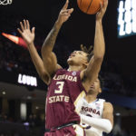 
              Florida State's Cameron Corhen (3) fights for a basket against Virginia during the first half of an NCAA college basketball game in Charlottesville, Va., Saturday, Dec. 3, 2022. (AP Photo/Mike Kropf)
            