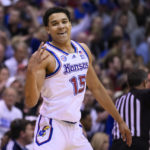 
              Kansas guard Kevin McCullar Jr. (15) celebrates a 3-point basket against Indiana during the first half of an NCAA college basketball game in Lawrence, Kan., Saturday, Dec. 17, 2022. (AP Photo/Reed Hoffmann)
            