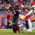 
              Denver Broncos quarterback Russell Wilson is sacked by Kansas City Chiefs linebacker Darius Harris, bottom, during the second half of an NFL football game Sunday, Dec. 11, 2022, in Denver. (AP Photo/Jack Dempsey)
            