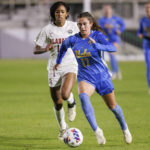 
              UCLA's Lexi Wright (17) works with the ball in front of Alabama's Gianna Paul during the first half of an NCAA women's soccer tournament semifinal in Cary, N.C., Friday, Dec. 2, 2022. (AP Photo/Ben McKeown)
            