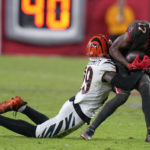 
              Cincinnati Bengals cornerback Cam Taylor-Britt (29) stops Tampa Bay Buccaneers wide receiver Russell Gage (17) during the second half of an NFL football game, Sunday, Dec. 18, 2022, in Tampa, Fla. (AP Photo/Chris O'Meara)
            