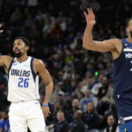 
              Dallas Mavericks guard Spencer Dinwiddie (26) celebrates after making a basket as Minnesota Timberwolves center Rudy Gobert (27) reacts during the second half of an NBA basketball game, Wednesday, Dec. 21, 2022, in Minneapolis. (AP Photo/Abbie Parr)
            