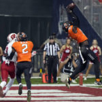 
              Oklahoma State linebacker Lamont Bishop (11) intercepts a pass intended for Wisconsin wide receiver Chimere Dike (13) during the first half of the Guaranteed Rate Bowl NCAA college football game Tuesday, Dec. 27, 2022, in Phoenix. (AP Photo/Rick Scuteri)
            
