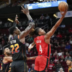 
              Houston Rockets guard Jalen Green (4) drives to the basket past Phoenix Suns center Deandre Ayton (22) during the first half of an NBA basketball game, Tuesday, Dec. 13, 2022, in Houston. (AP Photo/Eric Christian Smith)
            