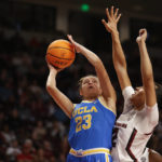 
              FILE - UCLA forward Gabriela Jaquez (23) shoots against South Carolina guard Brea Beal during the first half of an NCAA college basketball game in Columbia, S.C., Tuesday, Nov. 29, 2022. Women's college basketball has typically kept players around compared to the frequent early exits to the professional ranks that are so common on the men's side. But the women's game has gotten even older with players having extra eligibility from the COVID-19 pandemic. That has first-year players facing more fifth- and sixth-year players, creating a bigger gap to overcome in experience and strength than before. (AP Photo/Nell Redmond, File)
            