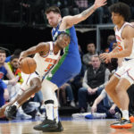 
              New York Knicks guard Immanuel Quickley drives against Dallas Mavericks guard Luka Doncic during the first quarter of an NBA basketball game in Dallas, Tuesday, Dec. 27, 2022. (AP Photo/LM Otero)
            