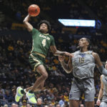 
              UAB guard Eric Gaines (4) is defended by West Virginia forward Jimmy Bell Jr. (15) during the first half of an NCAA college basketball game in Morgantown, W.Va., Saturday, Dec. 10, 2022. (AP Photo/Kathleen Batten)
            