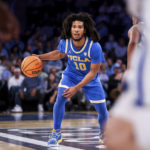 
              UCLA guard Tyger Campbell dribbles the ball during the first half of an NCAA college basketball game against Kentucky in the CBS Sports Classic, Saturday, Dec. 17, 2022, in New York. (AP Photo/Julia Nikhinson)
            