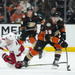 
              Anaheim Ducks' Sam Carrick (39) passes the puck as he is pressured by Carolina Hurricanes' Martin Necas (88) during the second period of an NHL hockey game Tuesday, Dec. 6, 2022, in Anaheim, Calif. (AP Photo/Jae C. Hong)
            