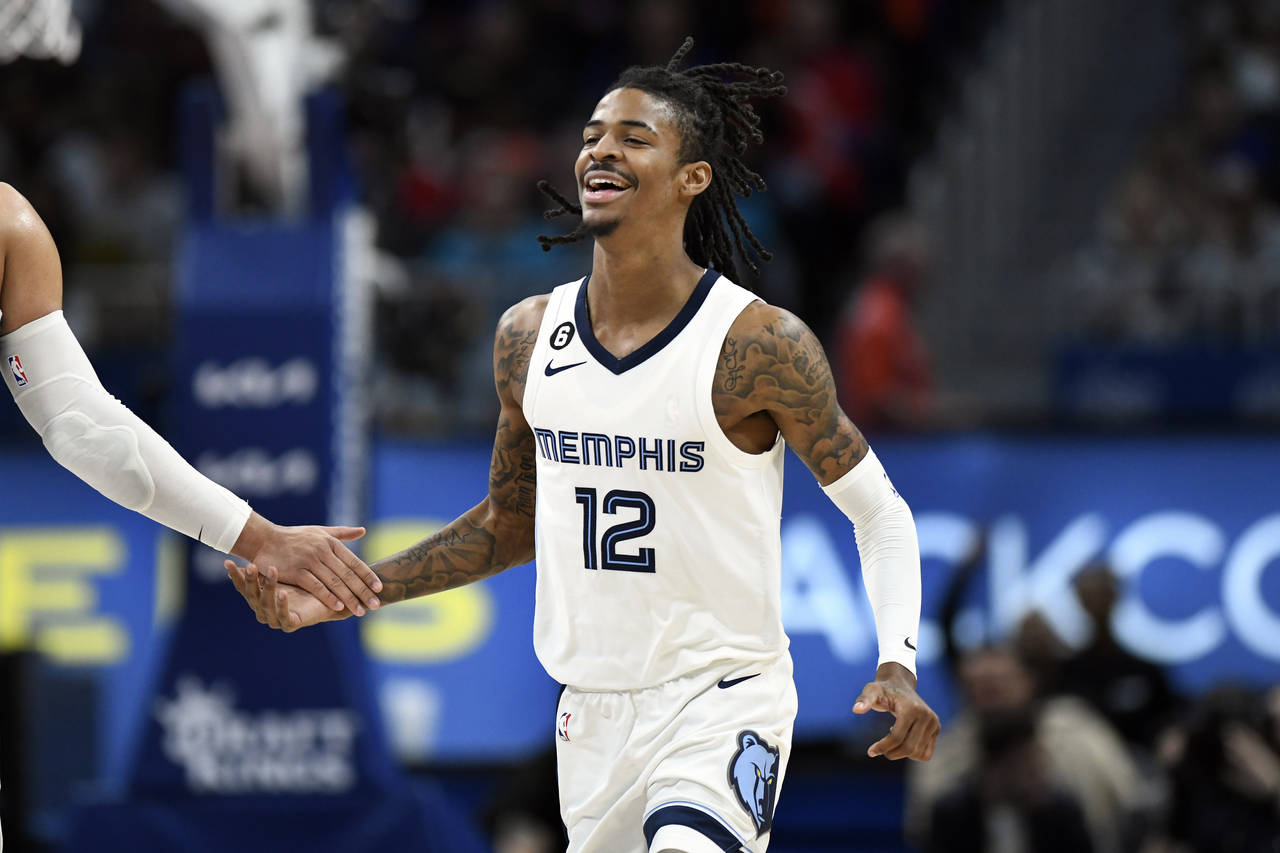 Memphis Grizzlies guard Ja Morant reacts after dunking against the Detroit Pistons during the secon...