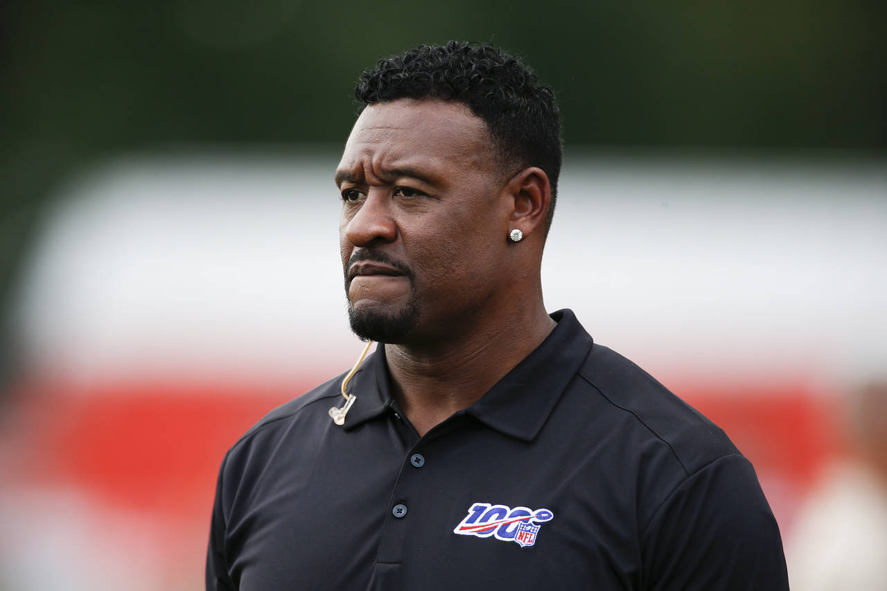FILE - Former NFL football player Willie McGinest Jr. watches the Cleveland Browns during practice ...