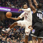 
              Cleveland Cavaliers guard Darius Garland (10) passes against Sacramento Kings forward Harrison Barnes (40) during the first half of an NBA basketball game, Friday, Dec. 9, 2022, in Cleveland. (AP Photo/Nick Cammett)
            