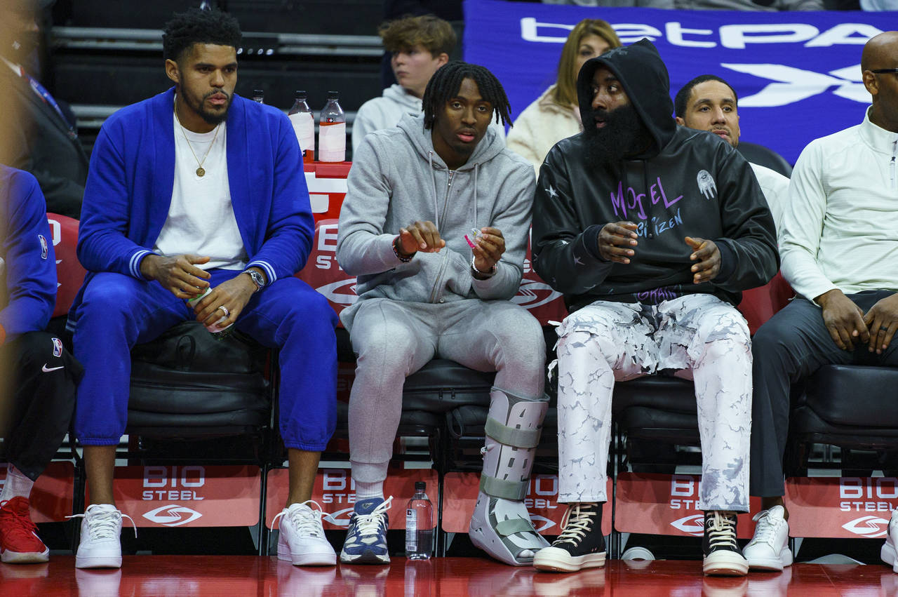 Philadelphia 76ers' Tobias Harris, left, Tyrese Maxey, center, and James Harden, right, look on fro...