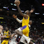 
              Los Angeles Lakers forward LeBron James goes to the basket as Miami Heat center Bam Adebayo, right, defends during the second half of an NBA basketball game, Wednesday, Dec. 28, 2022, in Miami. The Heat won 112-98. (AP Photo/Lynne Sladky)
            