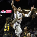
              Kansas State forward David N'Guessan (3) gets past Wichita State forward Gus Okafor (23) to dunk the ball during the first half of an NCAA college basketball game against Wichita State Saturday, Dec. 3, 2022, in Manhattan, Kan. (AP Photo/Charlie Riedel)
            