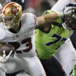 
              San Francisco 49ers running back Christian McCaffrey (23) runs against Seattle Seahawks defensive tackle Quinton Jefferson during the second half of an NFL football game in Seattle, Thursday, Dec. 15, 2022. (AP Photo/Stephen Brashear)
            