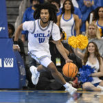 
              UCLA guard Tyger Campbell brings the ball up the floor while playing Oregon during the second half in an NCAA college basketball game, Sunday, Dec. 4, 2022, in Los Angeles. UCLA won 65 to 56. (AP Photo/John McCoy)
            