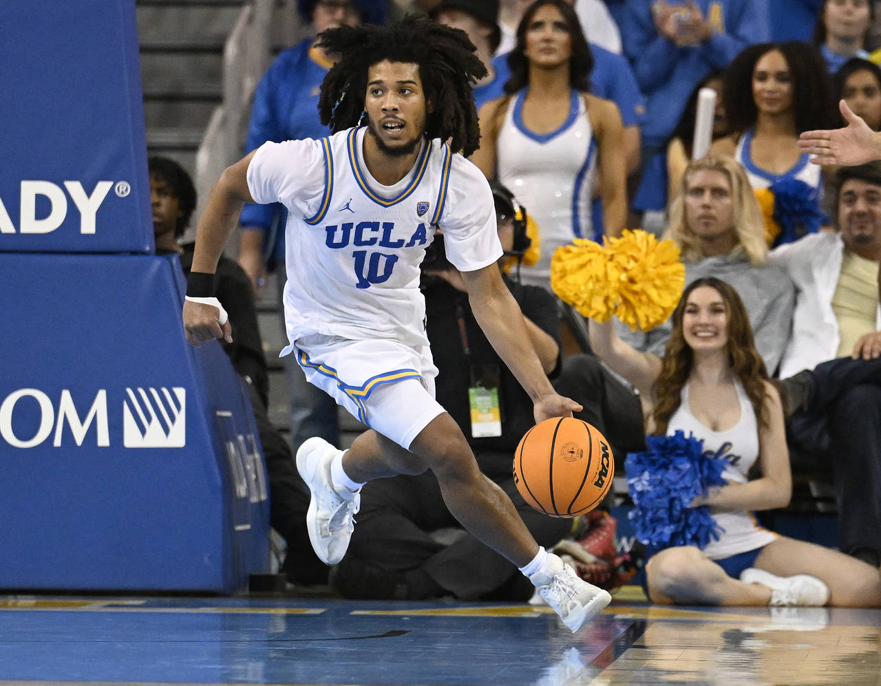 UCLA guard Tyger Campbell brings the ball up the floor while playing Oregon during the second half ...