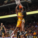 
              Minnesota forward Pharrel Payne's (21) shot is blocked by Arkansas-Pine Bluff guard AC Curry during the first half of an NCAA college basketball game on Wednesday, Dec. 14, 2022, in Minneapolis. (AP Photo/Craig Lassig)
            