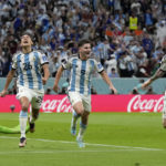 
              Argentina's Nahuel Molina, left, celebrates with Julian Alvarez, center, and Lionel Messi, right, after scoring the opening goal during the World Cup quarterfinal soccer match between the Netherlands and Argentina, at the Lusail Stadium in Lusail, Qatar, Friday, Dec. 9, 2022. (AP Photo/Ricardo Mazalan)
            