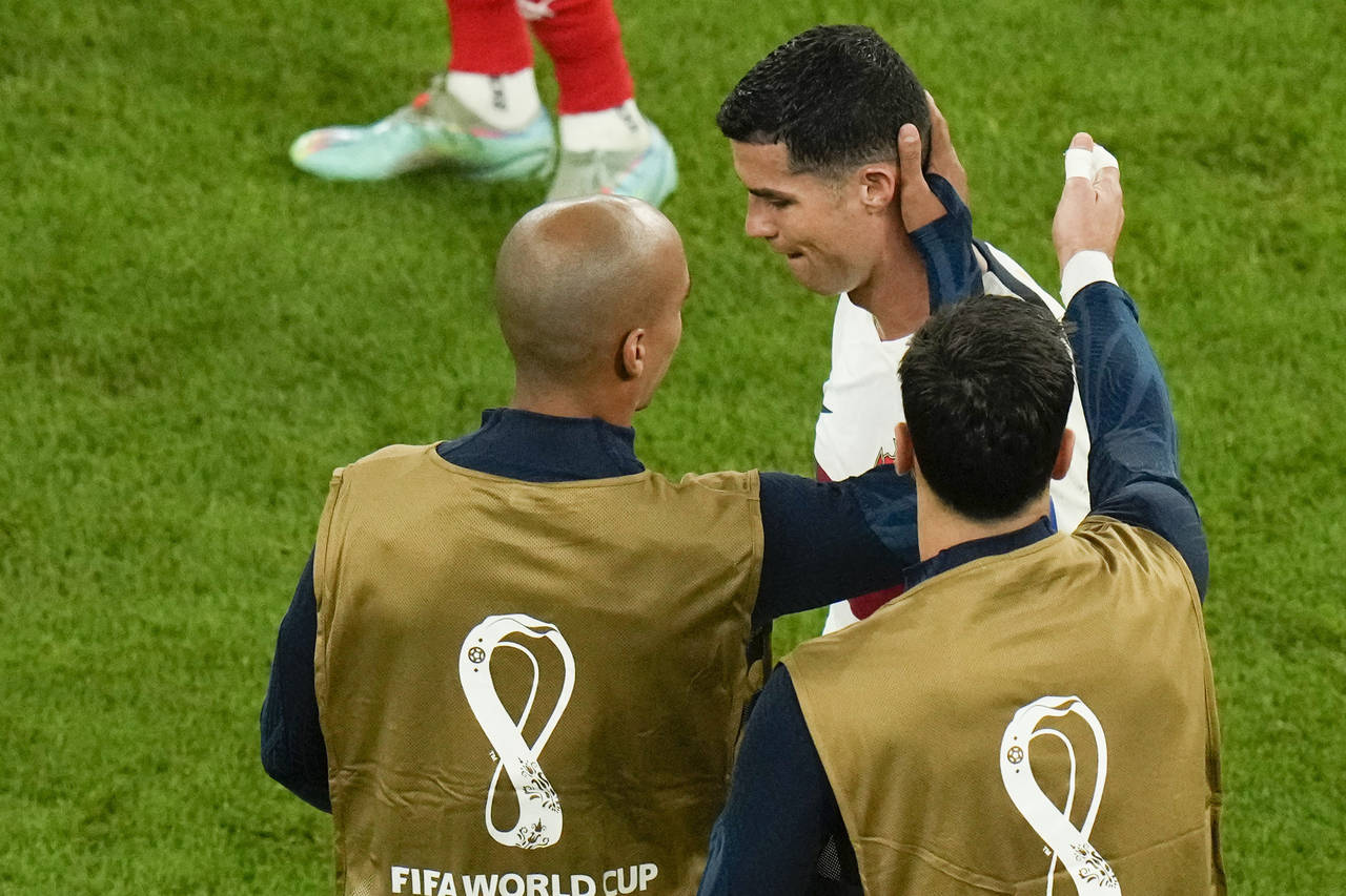 Portugal's Cristiano Ronaldo, right, reacts as he leaves the pitch after the World Cup quarterfinal...