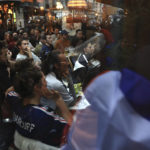 
              Supporters of France watch the World Cup final soccer match between Argentina and France, being shown live on television in a bar, in Paris, Sunday, Dec. 18, 2022. (AP Photo/Aurelien Morissard)
            
