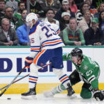 
              Edmonton Oilers defenseman Darnell Nurse (25) and Dallas Stars left wing Mason Marchment compete for control of the puck in the first period of an NHL hockey game, Wednesday, Dec. 21, 2022, in Dallas. (AP Photo/Tony Gutierrez)
            