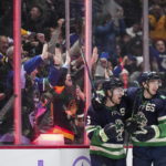 
              Vancouver Canucks' Brock Boeser, left, and Ilya Mikheyev celebrate Boeser's goal against the Arizona Coyotes during the third period of an NHL hockey game Saturday, Dec. 3, 2022, in Vancouver, British Columbia. (Darryl Dyck/The Canadian Press via AP)
            