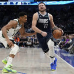 
              Dallas Mavericks guard Luka Doncic (77) is defended by Milwaukee Bucks forward Giannis Antetokounmpo (34) during the fourth quarter of an NBA basketball game in Dallas, Friday, Dec. 9, 2022. The Bucks won 106-105. (AP Photo/LM Otero)
            