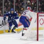 
              Vancouver Canucks' Jack Studnicka (18) knocks down Montreal Canadiens goalie Sam Montembeault's clearing pass and takes the puck around the net to score during the third period of an NHL hockey game in Vancouver, British Columbia, Monday, Dec. 5, 2022. (Darryl Dyck/The Canadian Press via AP)
            