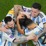 
              Argentina players celebrate with Argentina's Lionel Messi, left, who scored his side's first goal with a penalty shot during the World Cup semifinal soccer match between Argentina and Croatia at the Lusail Stadium in Lusail, Qatar, Tuesday, Dec. 13, 2022. (AP Photo/Hassan Ammar)
            