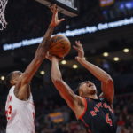 
              Toronto Raptors forward Scottie Barnes (4) drives to the net against Brooklyn Nets center Nic Claxton (33) during the first half of an NBA basketball game in Toronto, Friday, Dec. 16, 2022. (Cole Burston/The Canadian Press via AP)
            