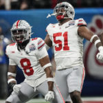 
              Ohio State defensive end Javontae Jean-Baptiste (8) and Ohio State defensive tackle Michael Hall Jr. (51) react to a sack on Georgia during the second half of the Peach Bowl NCAA college football semifinal playoff game, Saturday, Dec. 31, 2022, in Atlanta. (AP Photo/John Bazemore)
            