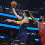 
              Chicago Bulls guard Coby White (0) fouls Golden State Warriors guard Klay Thompson (11), who scored during the first half of an NBA basketball game in San Francisco, Friday, Dec. 2, 2022. (AP Photo/Godofredo A. Vásquez)
            