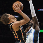 
              Atlanta Hawks guard Trae Young, left, is fouled by Orlando Magic guard Kevon Harris during the first half of an NBA basketball game, Monday, Dec. 19, 2022, in Atlanta. (AP Photo/Hakim Wright Sr.)
            