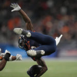 
              UTSA wide receiver Joshua Cephus, right, is upended by North Texas defensive back Logan Wilson (13) after making a catch during the second half of an NCAA college football game for the Conference USA championship in San Antonio, Friday, Dec. 2, 2022. (AP Photo/Eric Gay)
            