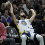 
              Golden State Warriors' Stephen Curry reacts from the bench during the second half of an NBA basketball game against the Milwaukee Bucks Tuesday, Dec. 13, 2022, in Milwaukee. (AP Photo/Morry Gash)
            
